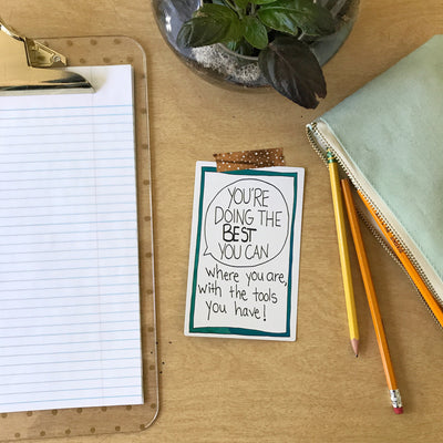 A teacher desk with a card from the Personal Pep Talk for Teachers strategy card deck